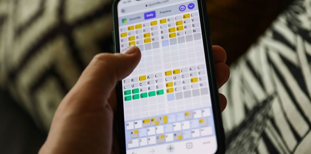 Quordle on a smartphone held in a hand