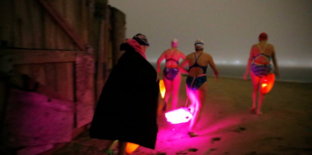 From left: Laurie Craigen, Kellie Latimer, Polly Madding, and Karen Nazor, swimmers from the L Street Bathhouse, headed out for an evening swim in Dorchester Bay last month.