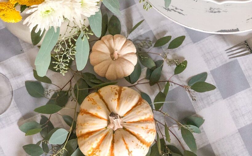 fall table setting with small pumpkins