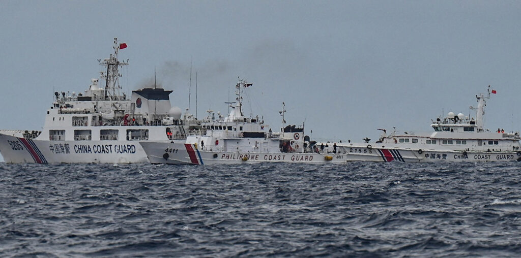 TENSION IN THE HIGHSEAS China Coast Guard ships are seen near the Philippine Coast Guard ship BRP Cape Engaño, as photographed from the BRP Cabra during a supply mission to Escoda (Sabina) Shoal in the South China Sea on Aug. 26, 2024.