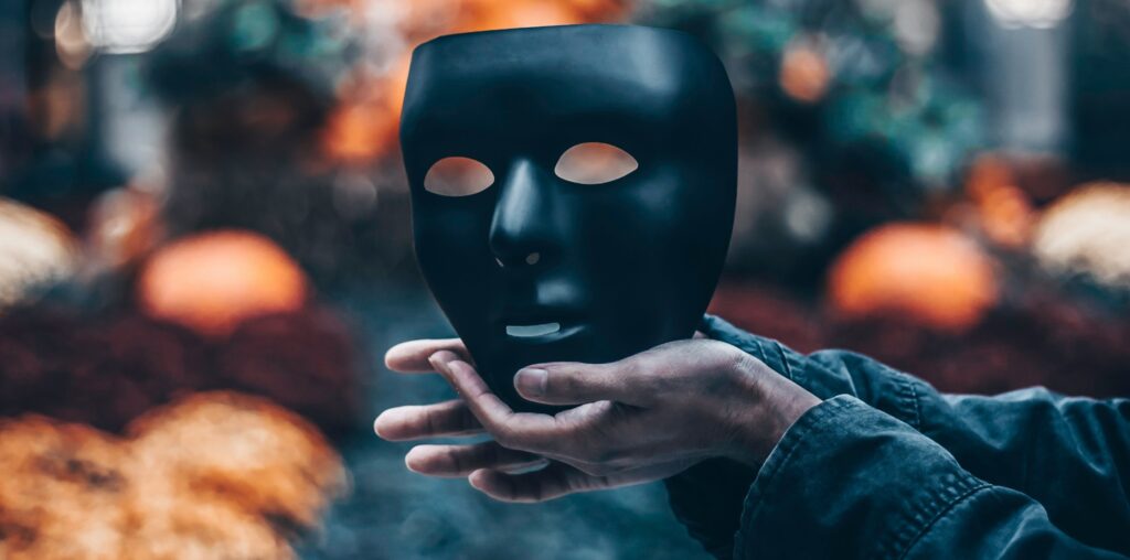 Person holding a mask following an AI sector study highlighting that record growth is masking serious challenges including skills, safety, infrastructure, security, and more, according to the authors of the report.