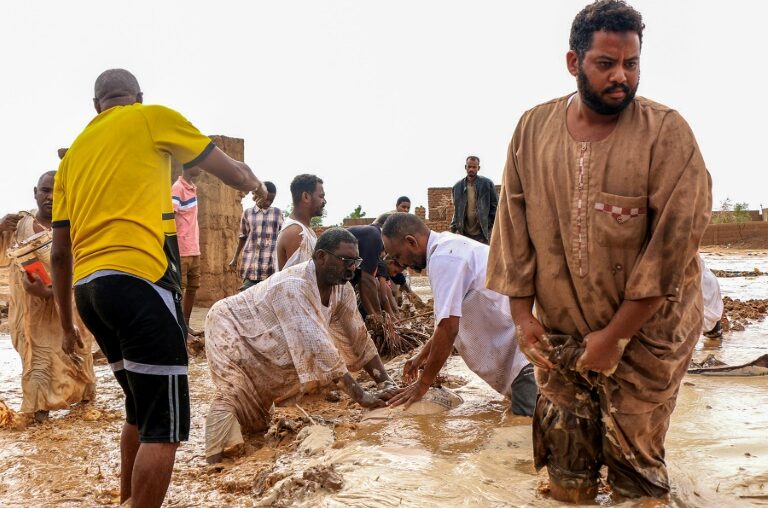 Men building a make-shift levee amid floods in Messawi, Sudan earlier this year