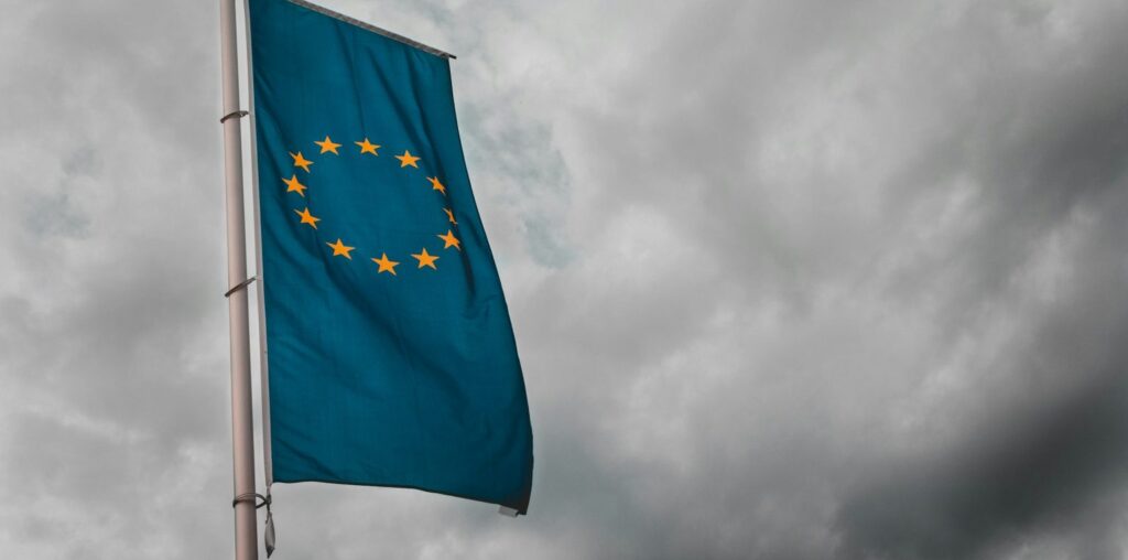 Flag of the European Union illustrating the looming EU AI Act, a framework that places stringent regulations on how businesses can integrate artificial intelligence.