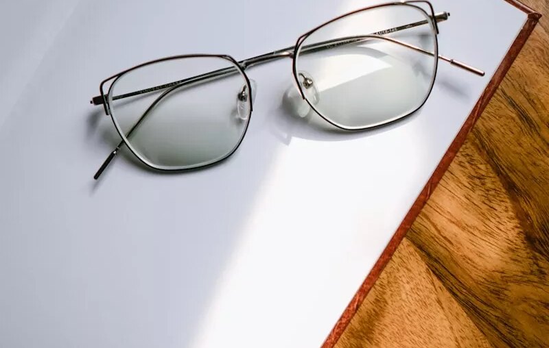 black framed eyeglasses on white table