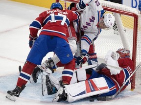 Montreal Canadiens' Josh Anderson (17) checks New York Rangers' Filip Chytil (72) into Canadiens goaltender Cayden Primeau (30)