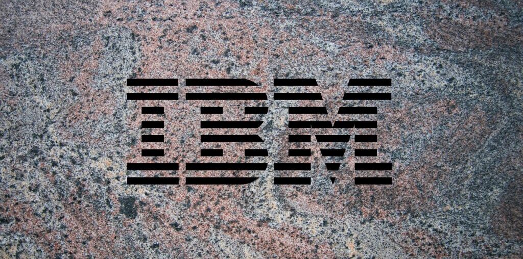 IBM logo on a granite background to illustrate the launch of the company's Granite 3.0 family of AI models alongside an open-source commitment.