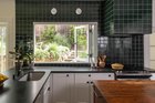 Kitchen renovation using emerald green tiles in a 1914 house, Oakland, California. By Studio June.