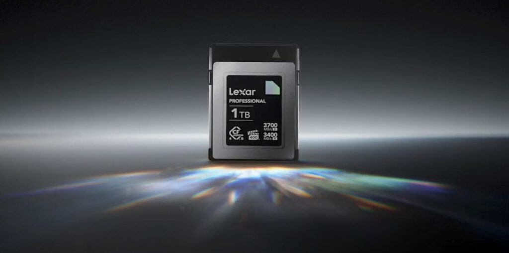 A Lexar Professional 1TB memory card is centered on a dark, reflective surface, illuminated by a prism effect of light below. The card displays specifications like 3700 MB/s read speed and 3400 MB/s write speed.