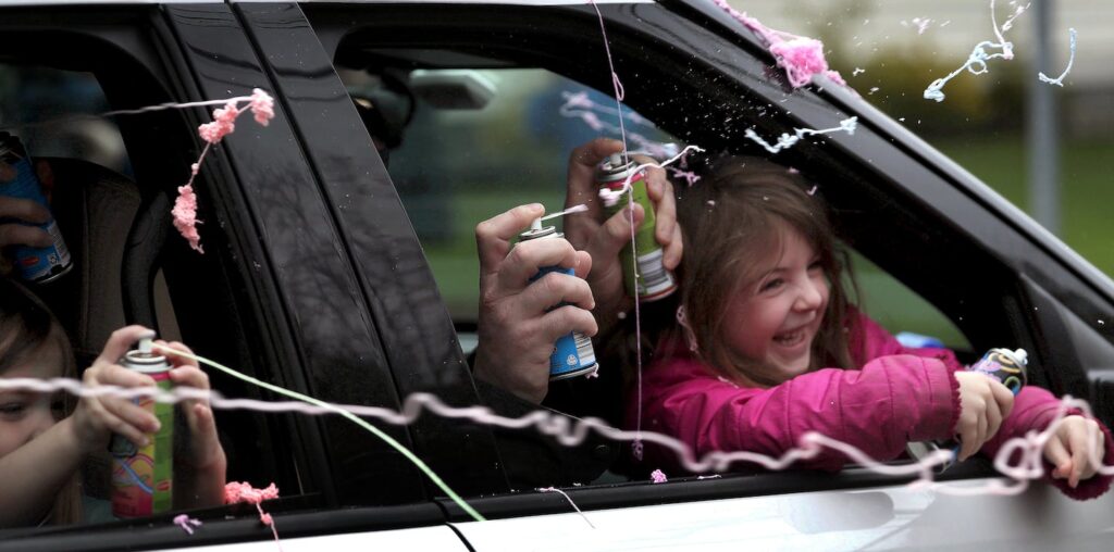 Dedham, MA - 4/30/2020: A drive-by birthday parade for Gavin Brennan of Dedham who celebrated his seventh birthday and successfully completing cancer treatment at Children's Hospital/Dana Farber. Gavin was among the first pediatric cancer patients in the nation to test positive for COVID-19 while undergoing chemotherapy. Pictured with Gavin are his sister Alexa, 4, and his parents Tim and April Brennan. - (Barry Chin/Globe Staff)