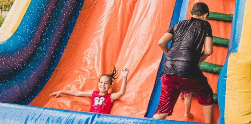 'My neighbor had been called in front of a board meeting [and] fined about $1000': Neighbor snitches on parents who let kids play on water slide bouncy house at all hours and flood other people's yards