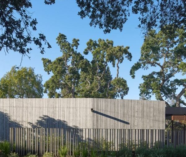 Tall "acoustic wall" buffers noise at Modal Home in Silicon Valley