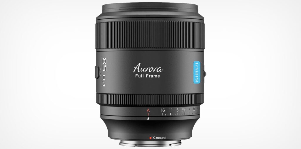 A black Aurora full-frame camera lens with blue accented detailing is shown against a white background. The aperture range is marked on the lens, and it features a silver mount at the base.