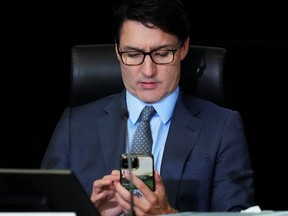 Justin Trudeau looking at his iPhone