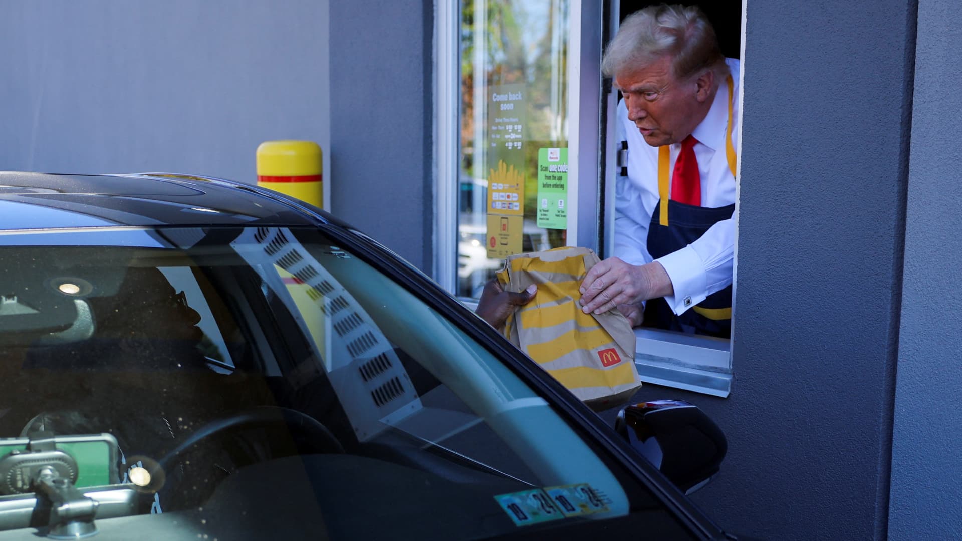 Trump works McDonald’s drive-thru, Harris campaign scoffs at stunt