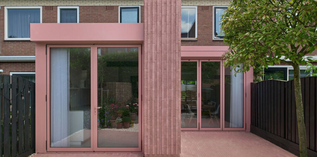 vertical pink concrete bricks wrap atlas architects' rosa home in the netherlands