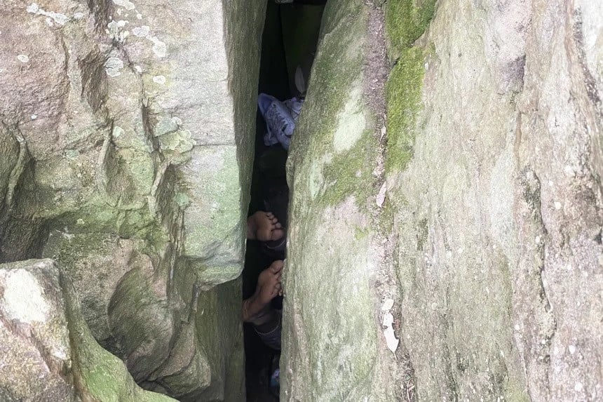 woman trapped between two rocks | Express News