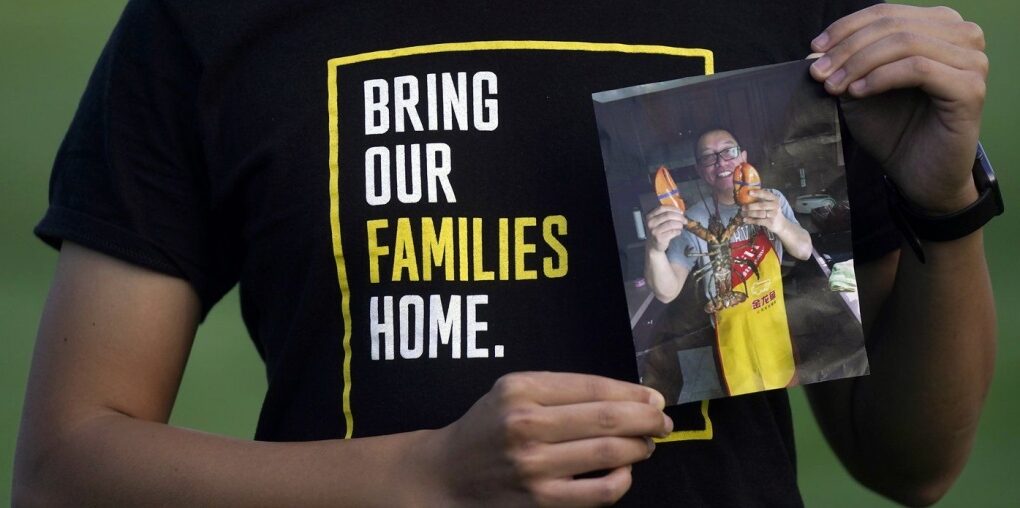 Harrison Li holds a photo of his father, Kai Li, as he poses for a photo, Tuesday, Jan. 23, 2024, in Palo Alto, Calif. (AP Photo/Jeff Chiu)