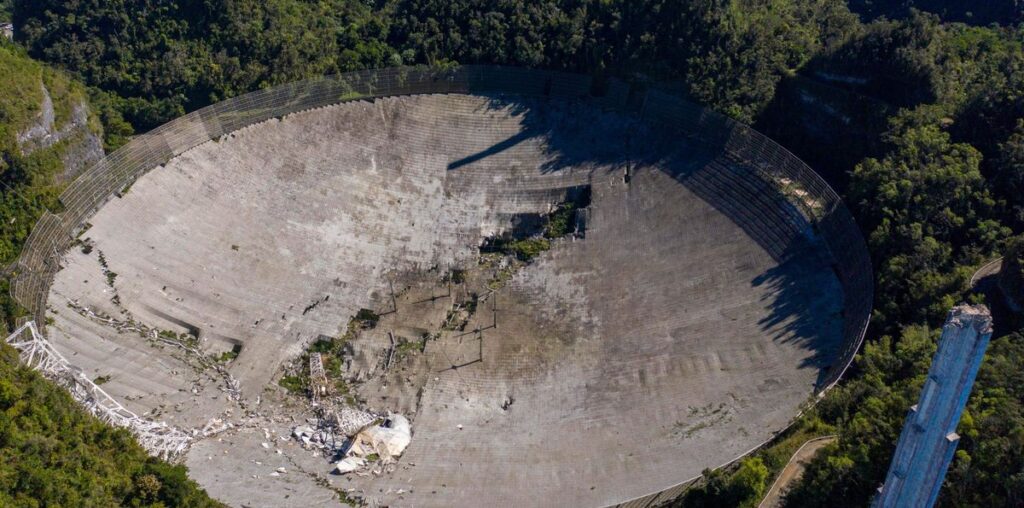 An aerial view of the massive radio dish at Arecibo Observatory after the telescope's collapse.