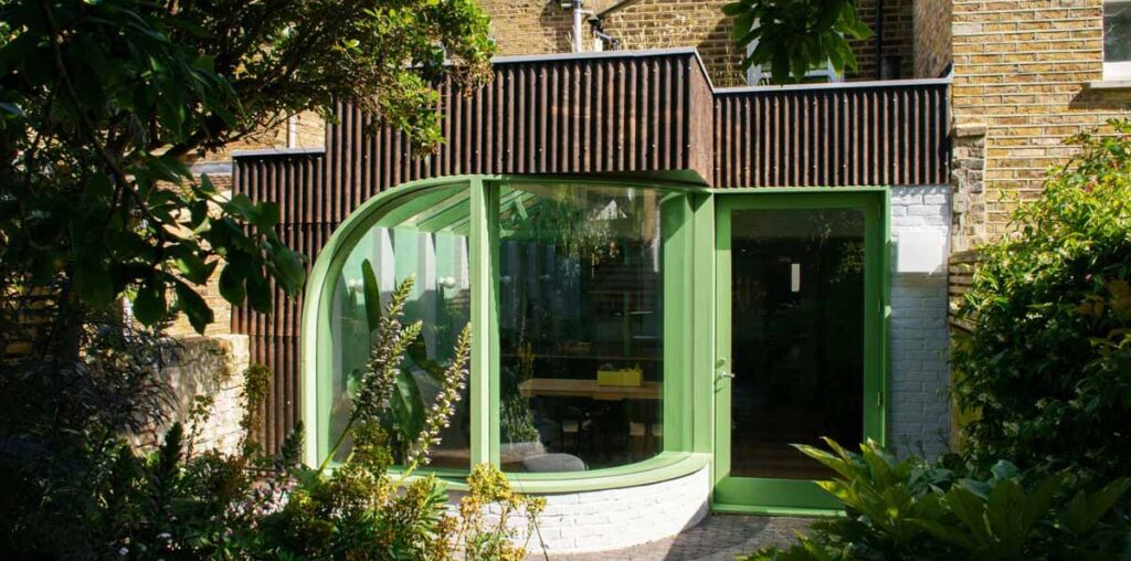 A House Extension With A Curved Window Makes Room For A New Kitchen At This Home In London