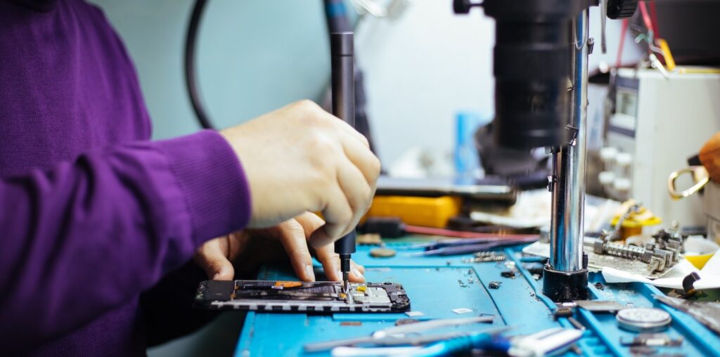 Technician repairing a smartphone.