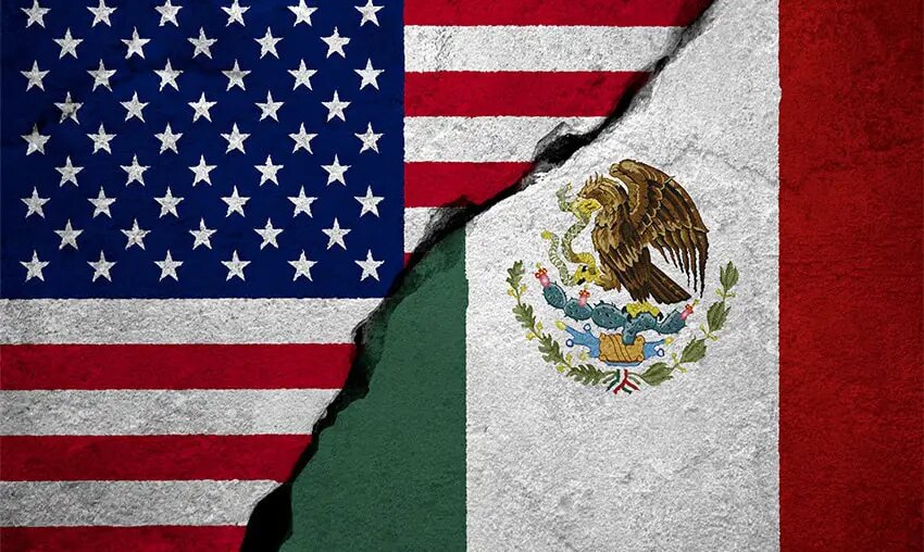 U.S. and Mexican flags with a concrete-like crack running between them.