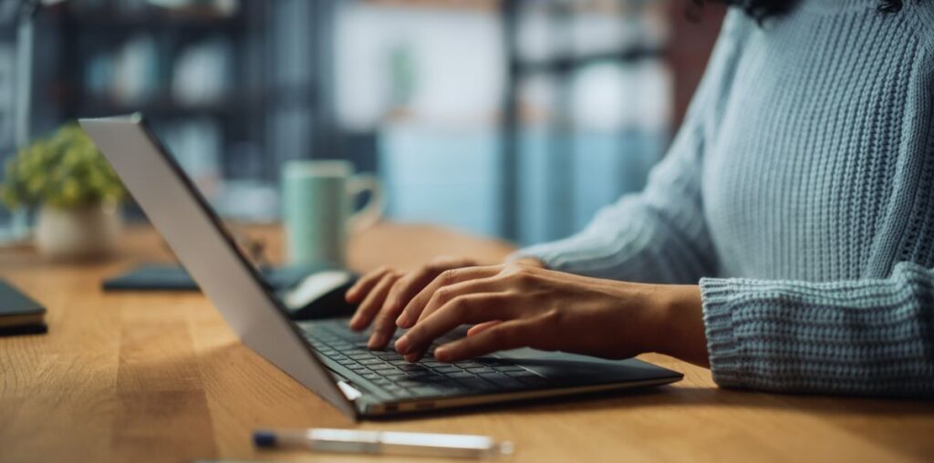 A person typing on a laptop.