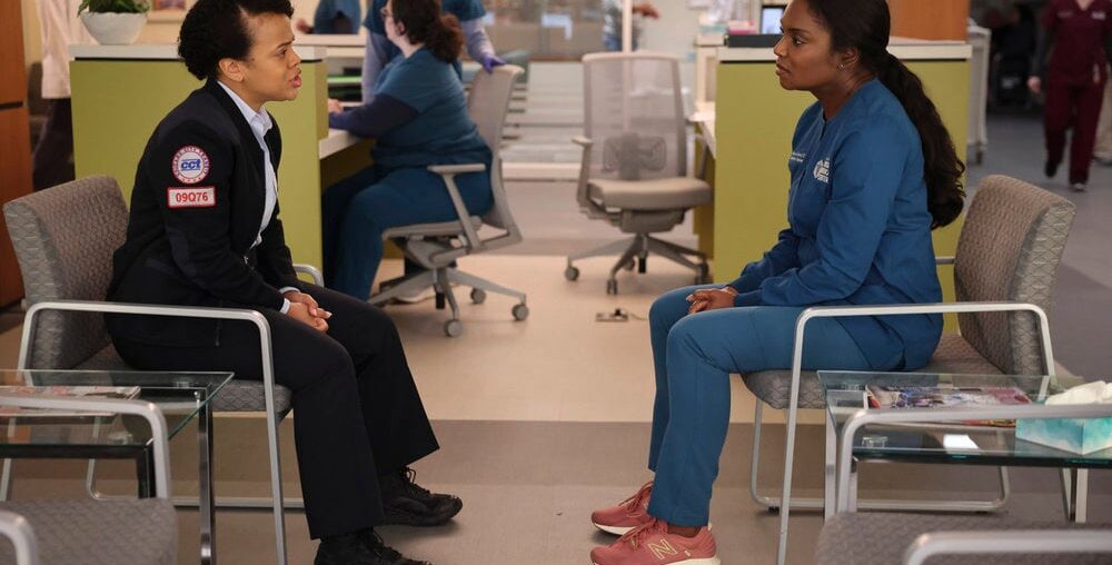 Maggie sitting with a rescue worker on Chicago Med Season 10 Episode 6