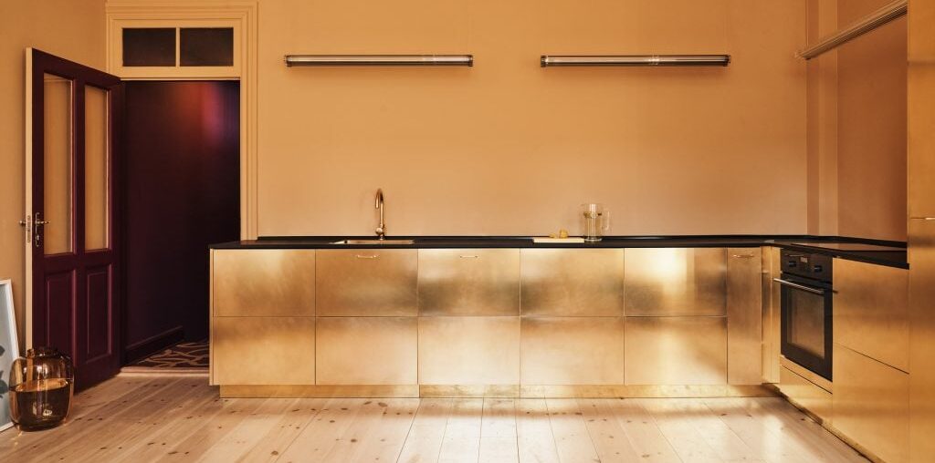 Eight kitchens where metallic gold surfaces add a regal touch