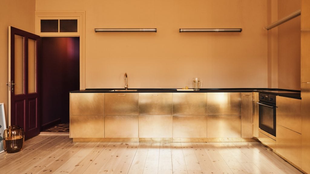 Eight kitchens where metallic gold surfaces add a regal touch