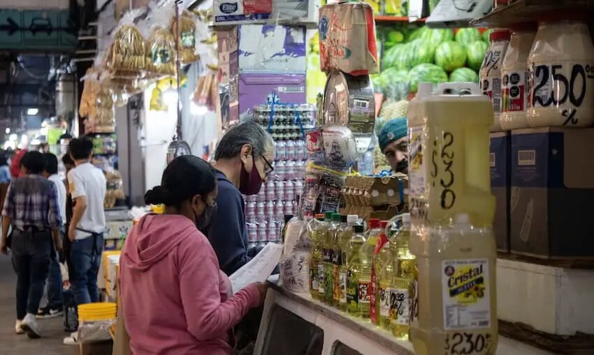 Residents fill their list at a grocery store, at the Central de Abastos, Mexico City.