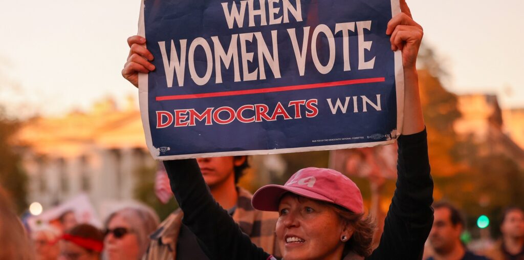 A woman in Washington DC carries a pro-Democrat sign (Image: Sipa USA/Robyn Stevens Brody)