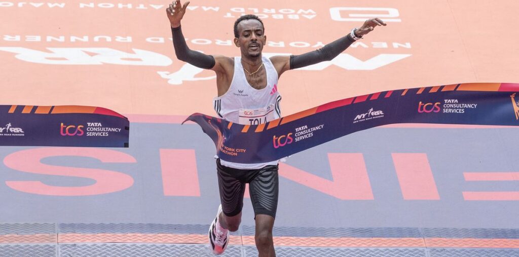 Tamirat Tola of Ethiopia crossing finish line as a winner with time 2:04:58 of TCS New York City marathon in open men's division in Central Park. Tola sets NYC Marathon course record to win men's race.