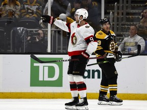 Josh Norris of the Ottawa Senators celebrates his power-play goal as Brad Marchand of the Boston Bruins skates by.