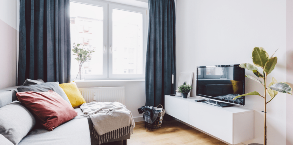 Apartment living room with blue curtains.