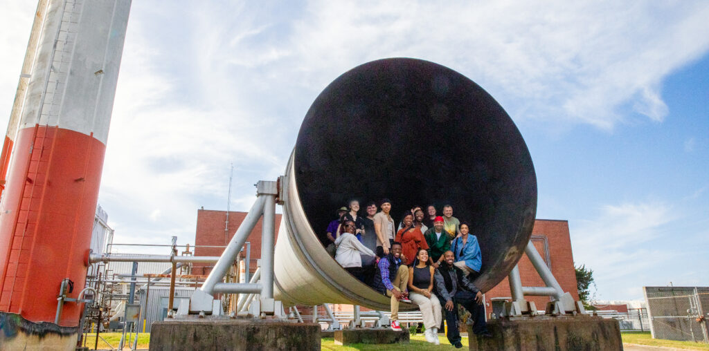 Members of the cast and crew of "Ain't Too Proud - The Life and Times of the Temptations" pose for a photo inside of the 8-foot high-temperature tunnel at NASA's Langley Research Center in Hampton, Virginia.