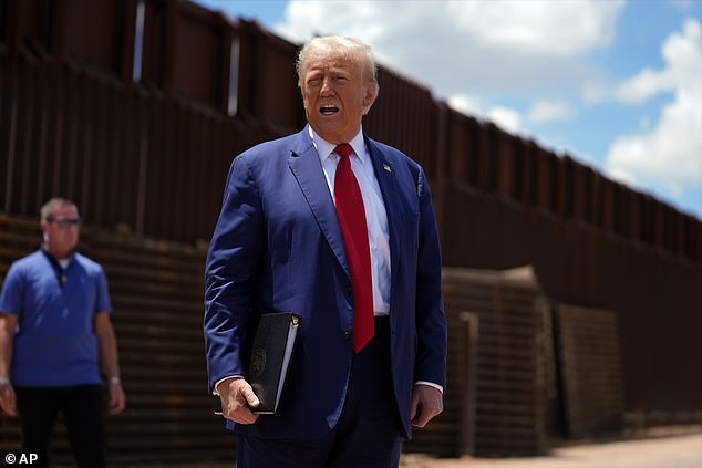 Former President Donald Trump is photographed standing in front of the border wall in August during his reelection bid. The now president-elect has vowed to slap a 25 percent tariff on Mexico and Canada, suggesting they should be the ones to curb border crossings