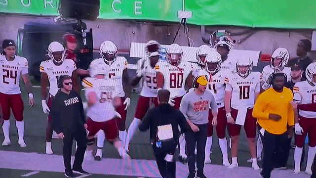 ULM assistant coach Cameron Blankenship tries to attack one of his players.