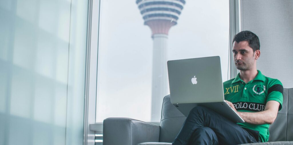 Man working on a computer illustrating a report from the Tony Blair Institute highlighting AI's potential impact on the workforce, including the opportunities and risks to the labor market and how government and policymakers can mitigate the challenges.