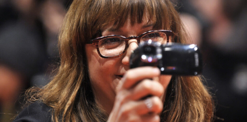 woman films with a digicam.