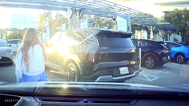 A driver begins to pull into a space in the parking lot of Fashion Valley Mall in San Diego, California, but was blocked by an individual appearing intent on reserving the space