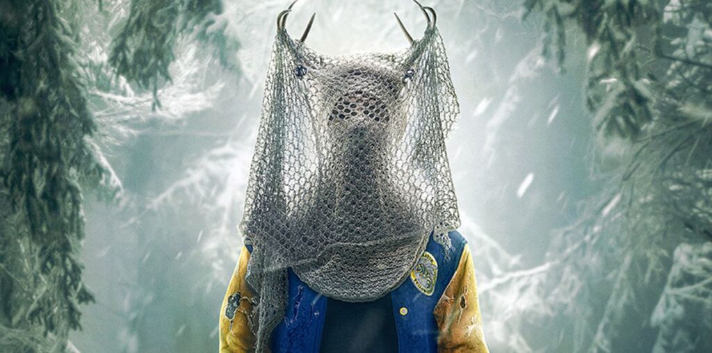 A person stands with antlers on their head covered by netting