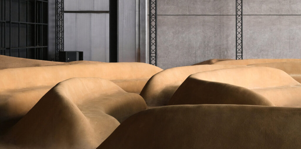 bottega veneta sculpts sand-colored seats into patterns of sound waves for dubai installation