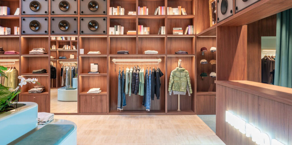 el departamento installs massive wooden bookshelf for nude project's new store in barcelona