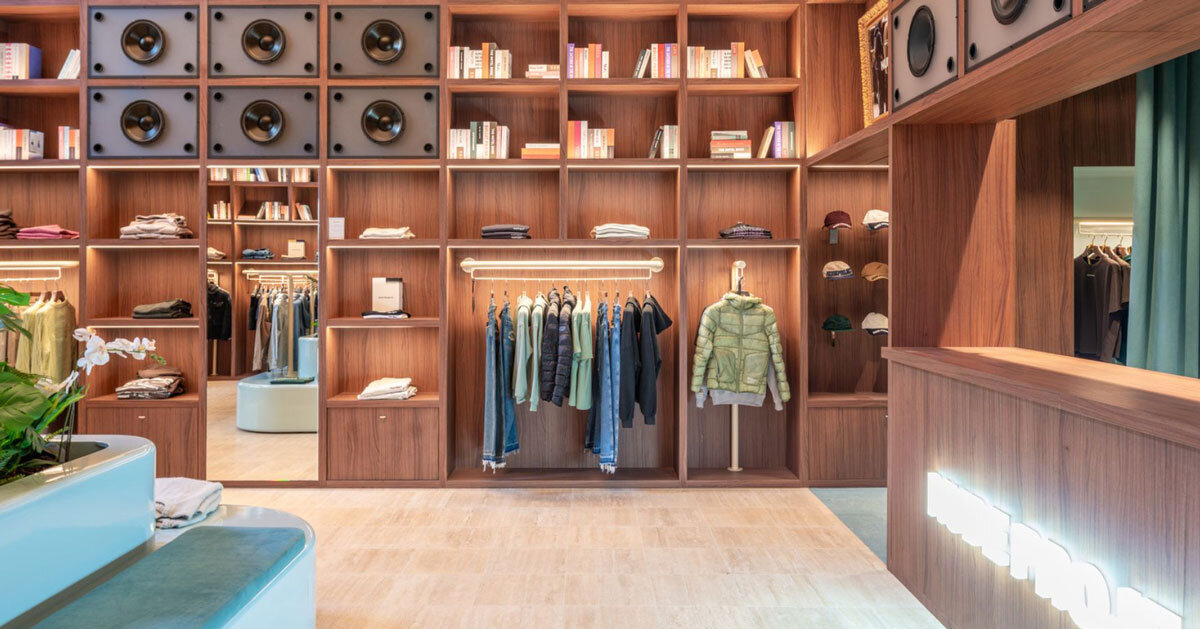 el departamento installs massive wooden bookshelf for nude project’s new store in barcelona