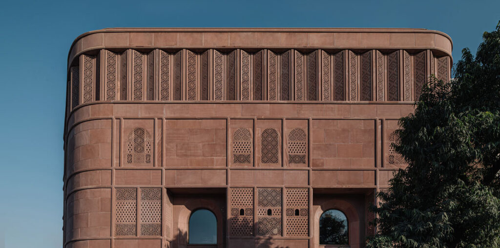 hand-carved red sandstone clads jewelry store's facade by studio lotus in jaipur